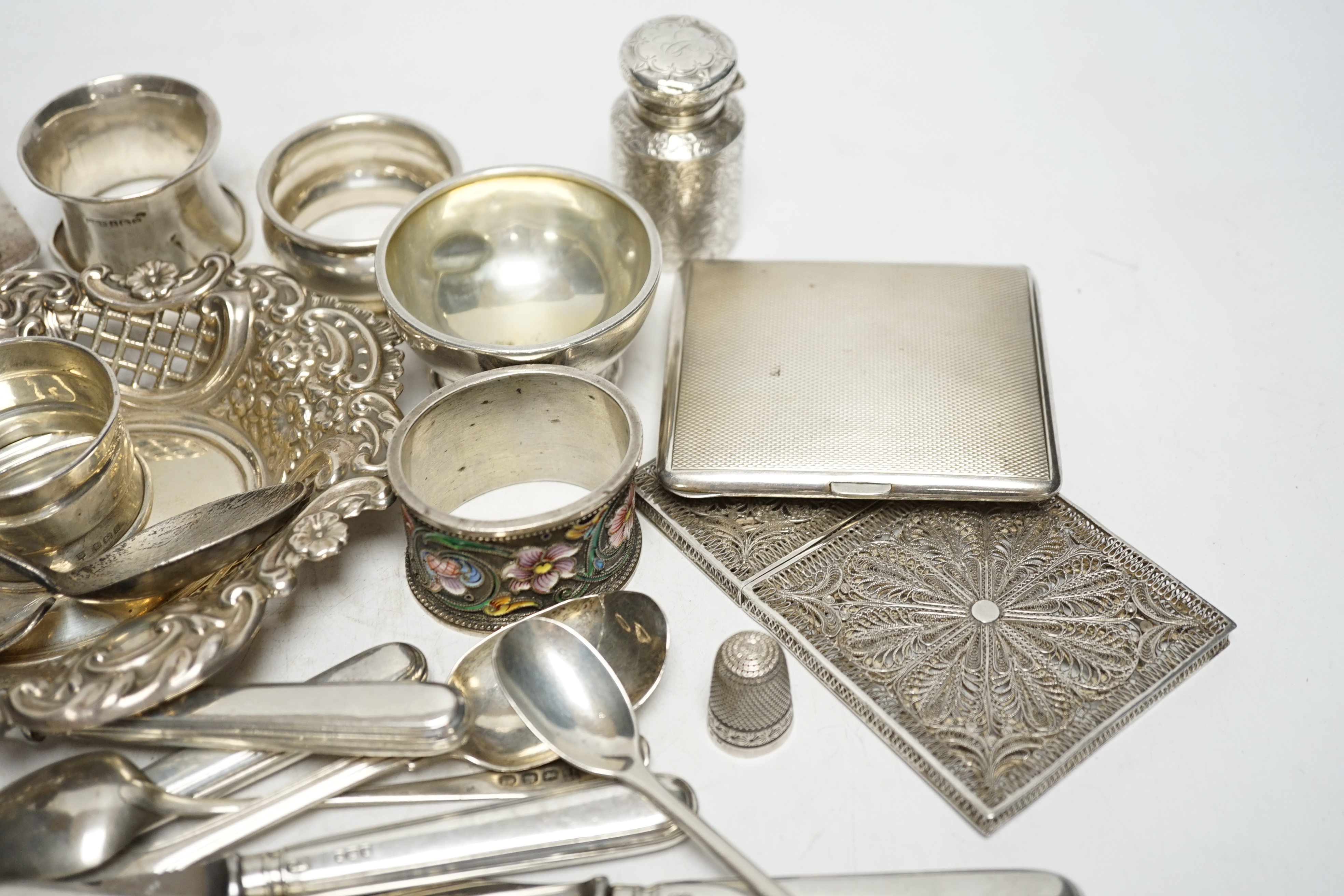 A quantity of assorted silver ad white metal items including a Russian 84 zolotnik and cloisonné enamel napkin ring, bon bon dish, scent bottle, cutlery, toast rack, cigarette case etc. Condition - fair to poor